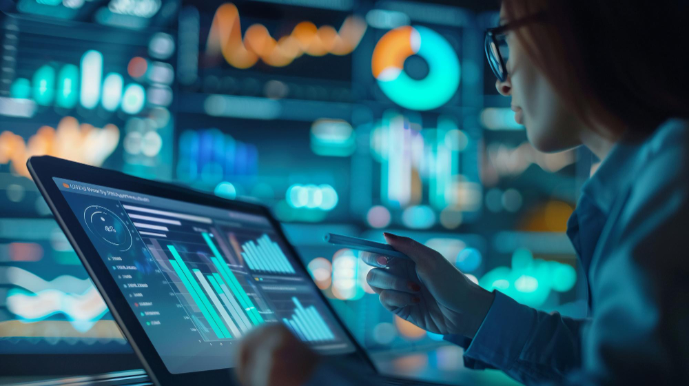 Mulher com graduação EaD em data science, em um laboratório utilizando um computador para analisar diversos gráficos com dados. Ao fundo, diversas telas com diferentes gráficos.