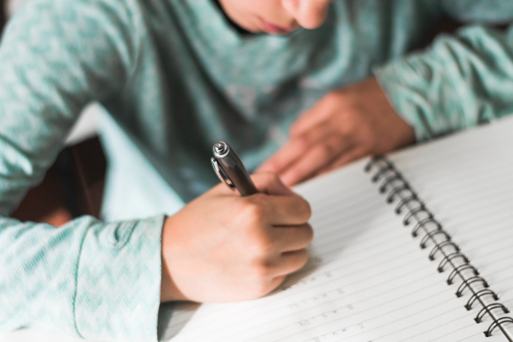 Jovem estudante treinando técnicas de redação, utilizando repertório sociocultural